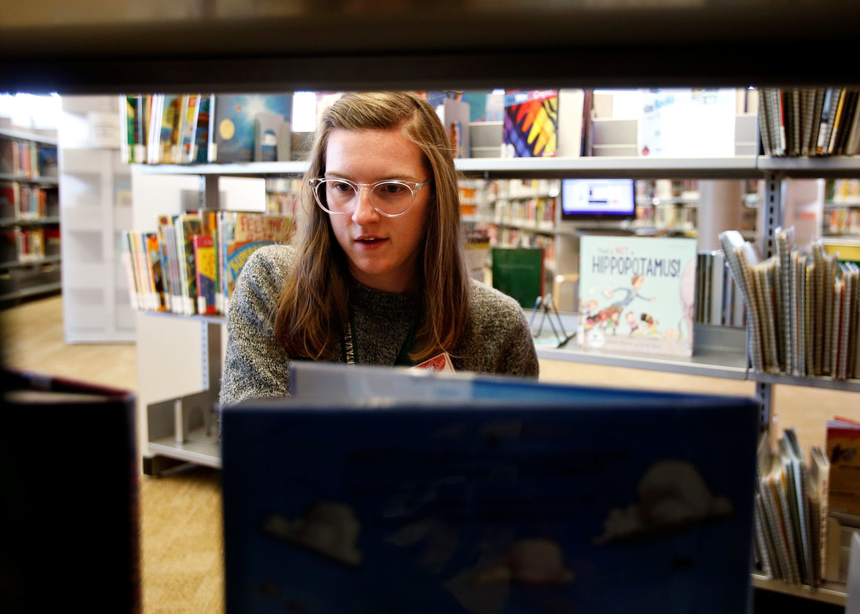 Librarian Molly Oullette shelves books